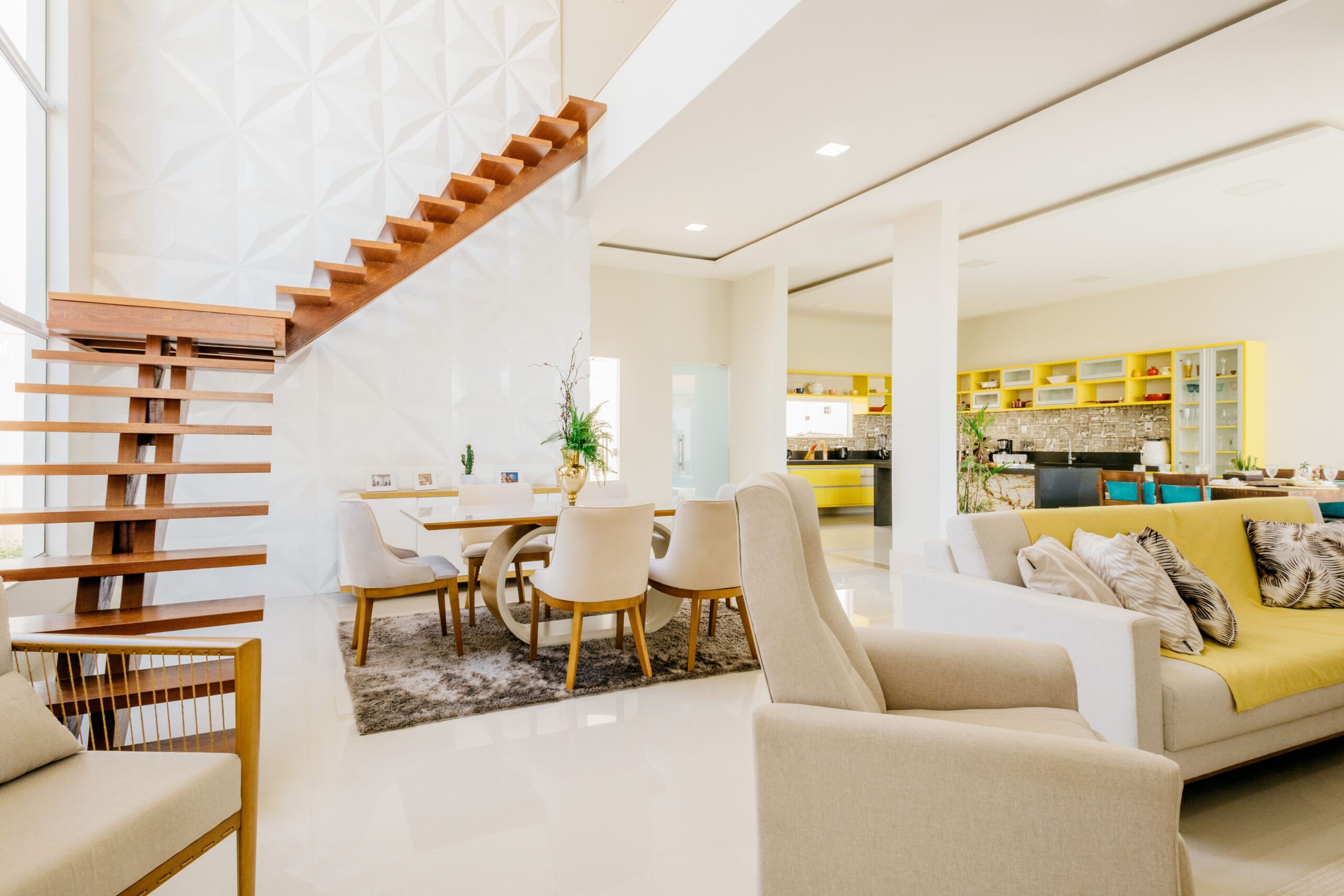 Bright open-plan home interior with a wooden staircase connecting two floors
