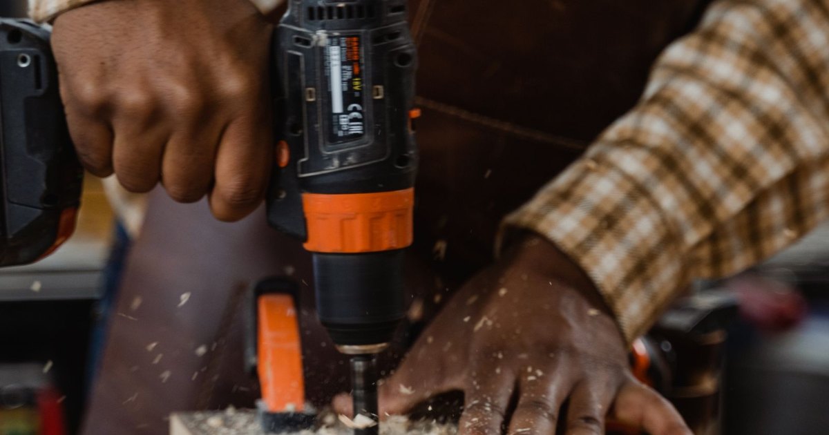 Tradesperson using a power drill Tradesperson using a power drill