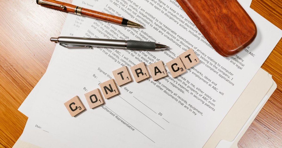 Printed contract and pen on a desk